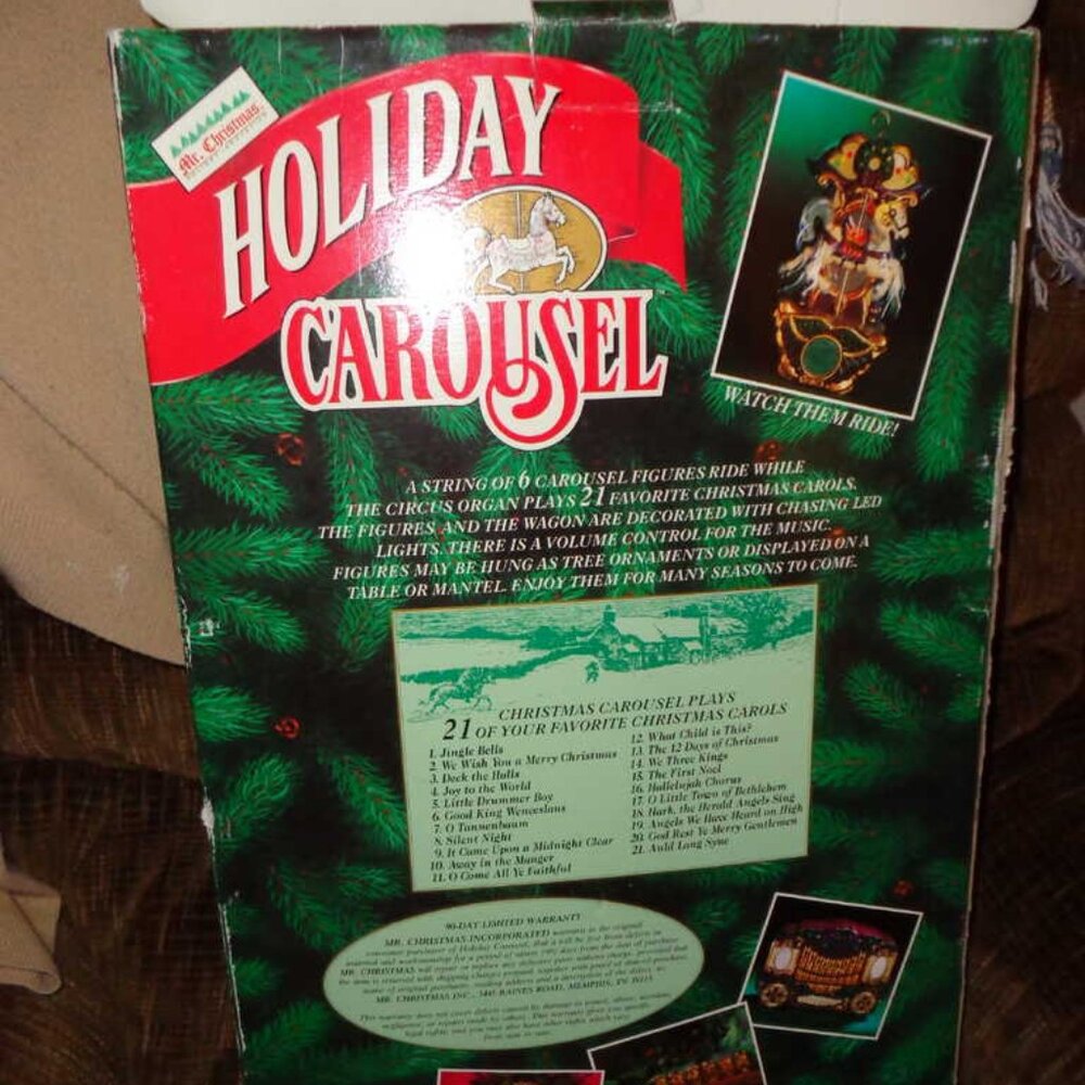 Holiday Carousel w/lights and carriages.  Plays 21 songs.  Electric.